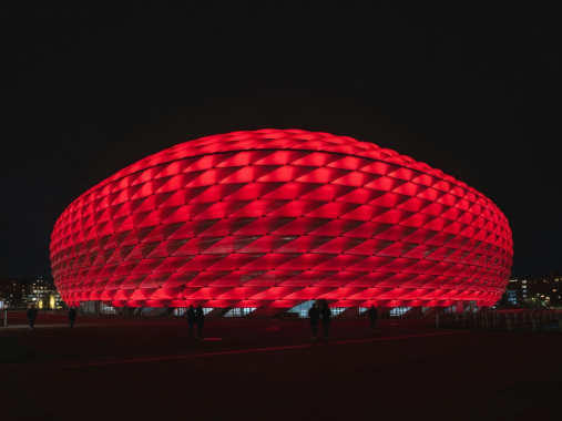 Allianz Arena illuminated red facade at night in Munich
